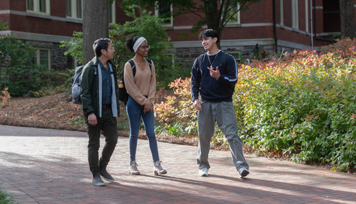 Three undergraduate students talk and walk through Georgia Tech’s campus.